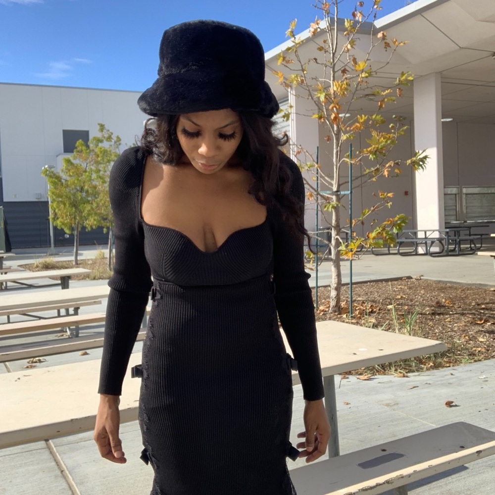 black  sweater dress, a square neckline, long sleeves, a slit hem